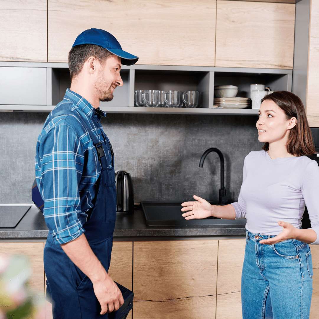 photo shows a water treatment professional explain water treatment to homeowner