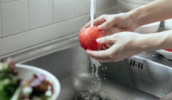 washing apple with clean water