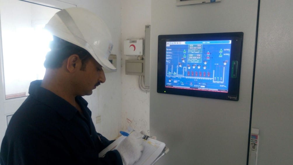 photo of an operator monitor a sewage treatment plant