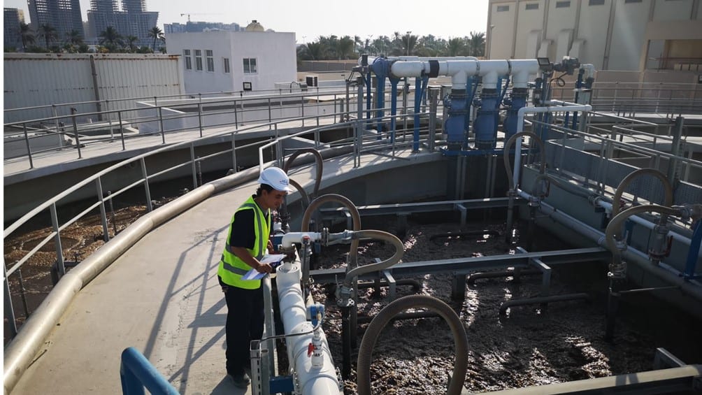 photo of an operator monitor a sewage treatment plant
