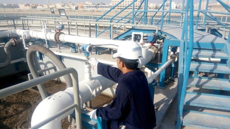 photo of an operator monitor a sewage treatment plant