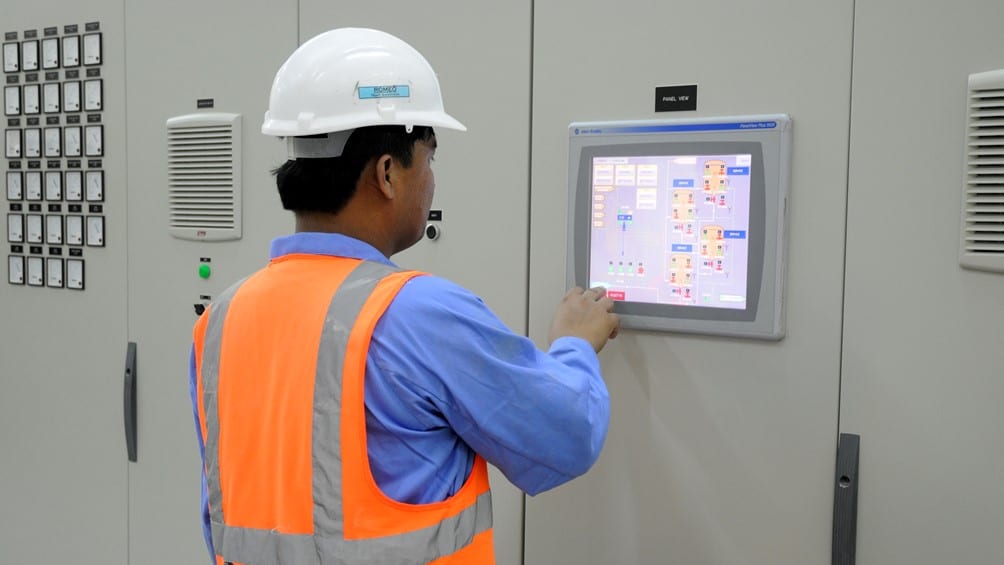 photo of an operator monitor a sewage treatment plant