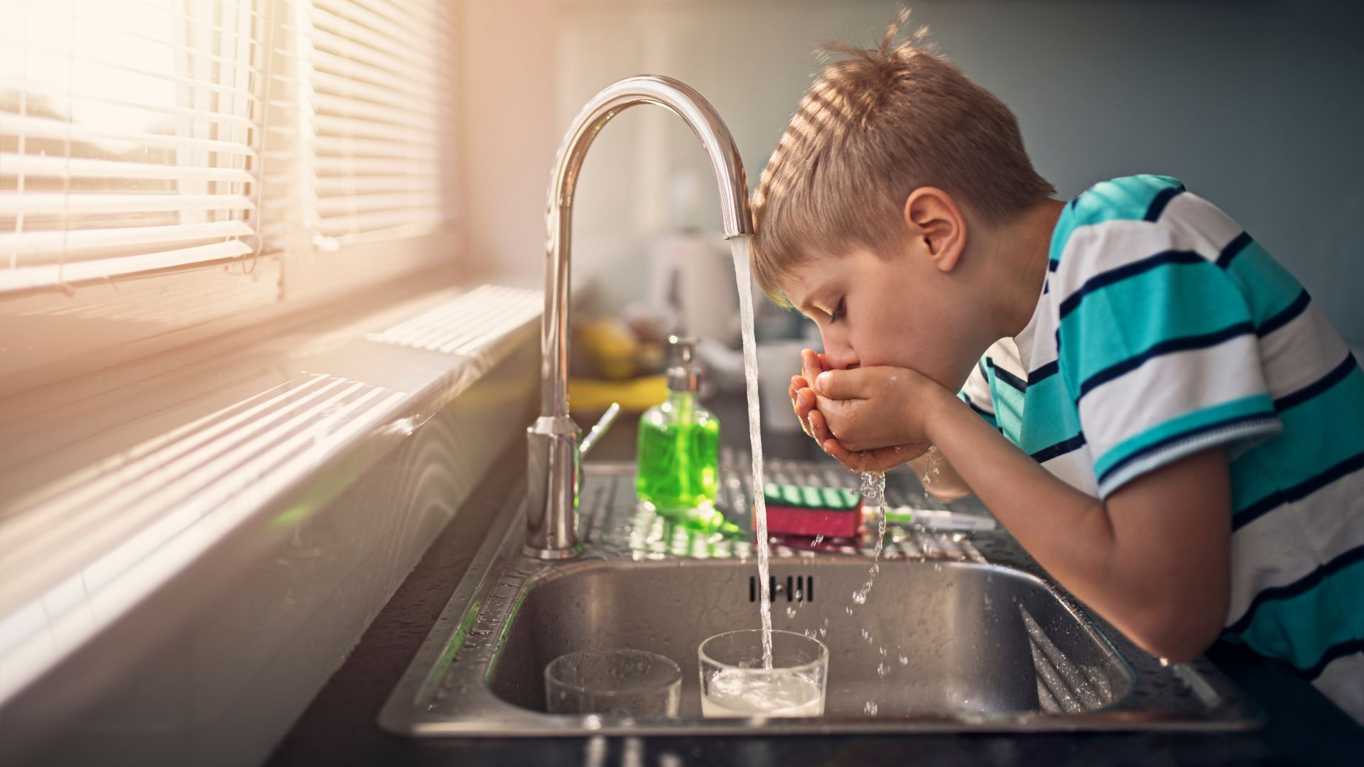 Child drink water from tap